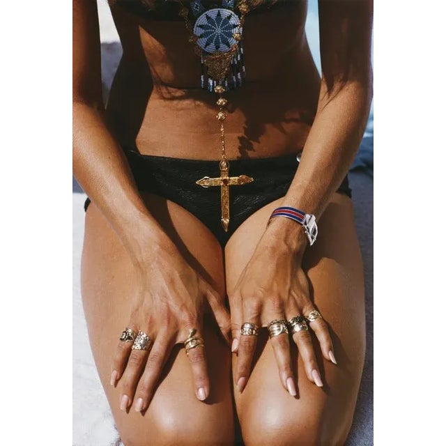 Capri Tan 1968 1968, A kneeling sunbather shows off her rings and pendant on a beach in Capri, Italy. (Photo by Slim...