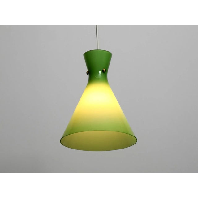- a mid-century overglass diabolo pendant lamp - made in austria - the glass is light green on the outside and white on...