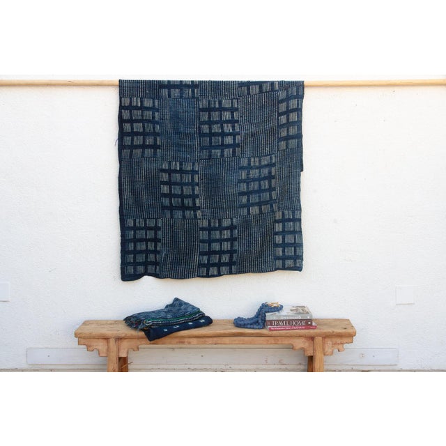 A masterwork of Malian textile heritage featuring deep indigo saturation and symbolic geometric motifs. Originating from...