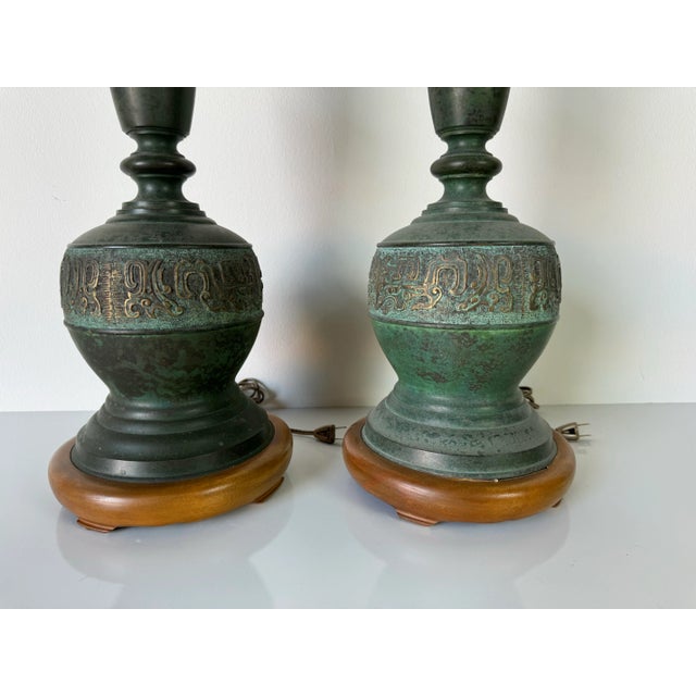 Pair of Vintage Chinoiserie James Mont style table lamps. Brass embossed Hollywood Regency Chinoiserie lamps makes a...