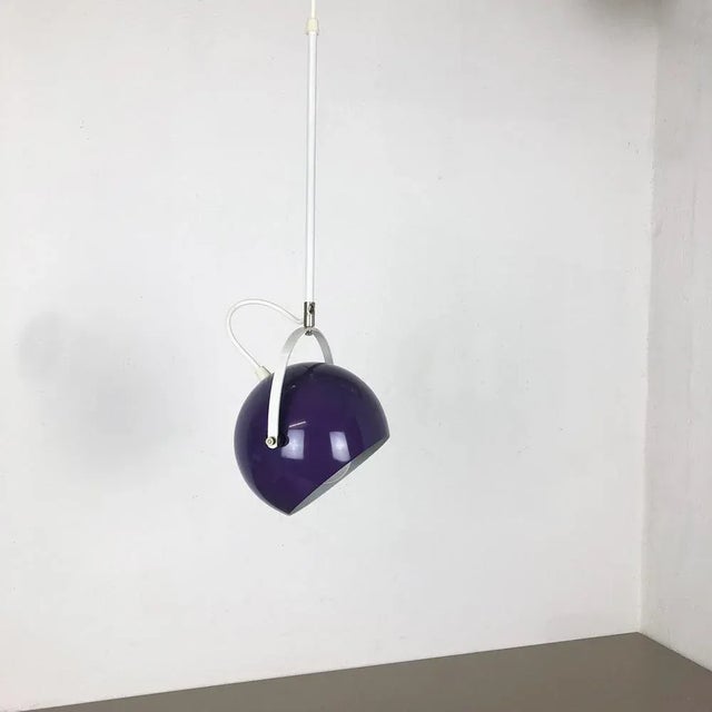 Purple spot hanging light. Origin: Germany, 1970s. This 1970s hanging spot light was made in Germany. The light has a...