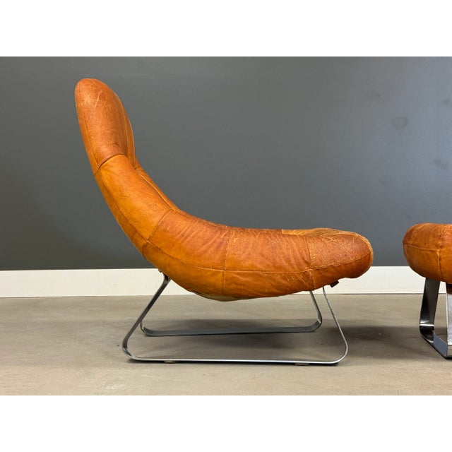 A mid century modern leather Earth Chair and ottoman with chrome sled bases designed by Percival Lafer. Made in Brazil....