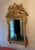 Large Louis XVI Style Giltwood Mirror with ornately carved crest featuring gardening / harvest themes. The carvings...