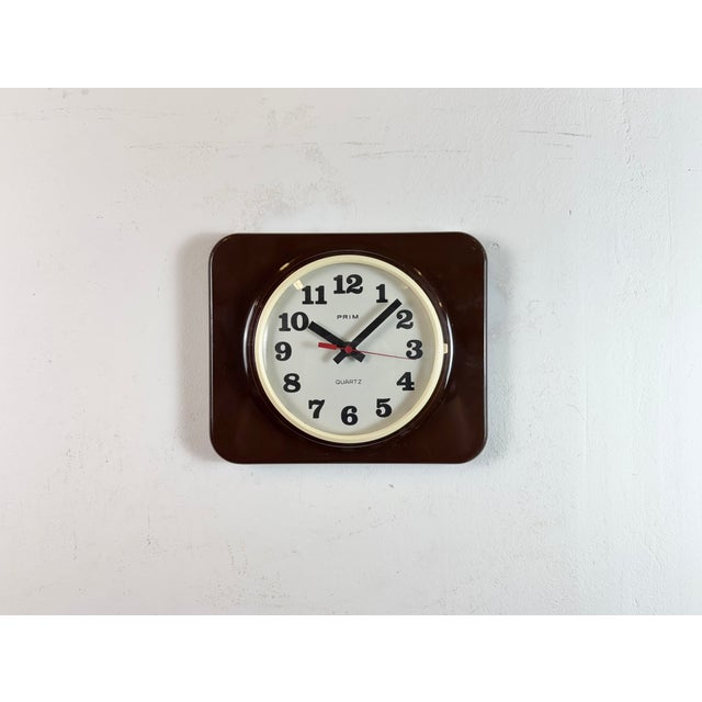 Vintage bakelite wall clock was made by Prim in former Czechoslovakia during the 1970s - 1980s. It features a brown...