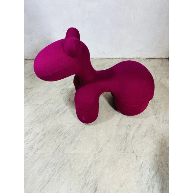 The Pony chair. This chair features a sculptural, organic design with bold curves and a distinctive shape, which are...