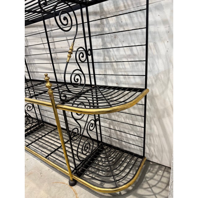 Quintessential vintage 1920’s French baker’s rack stylishly made of brass and wrought iron. Has 3 generous shelves to...