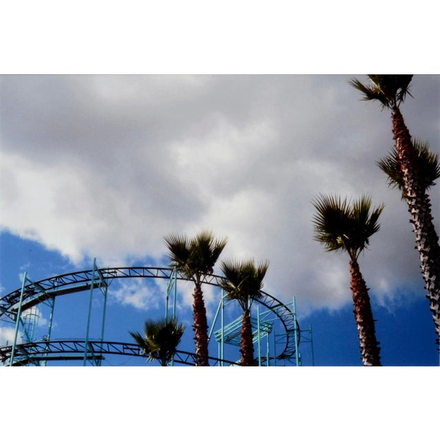 Wonderful color photograph of the roller coaster and palm trees at the Santa Cruz Boardwalk by California artist Deborah...