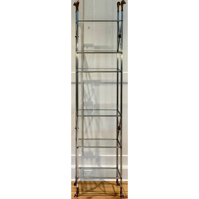 A striking French mid-century etagere in the Maison Jansen style, blending classical form with bold materials – brass,...