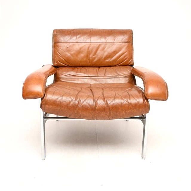 A stylish and very comfortable vintage leather and chrome armchair by Pieff. This was designed by Tim Bates, it was made...