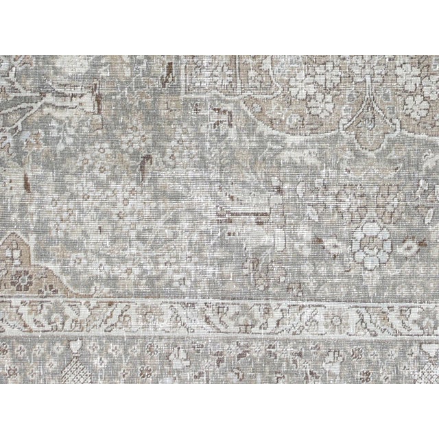 This lavish hand-knotted Persian Tabriz rug adds the perfect touch of elegance to any space. Its intricate design features...