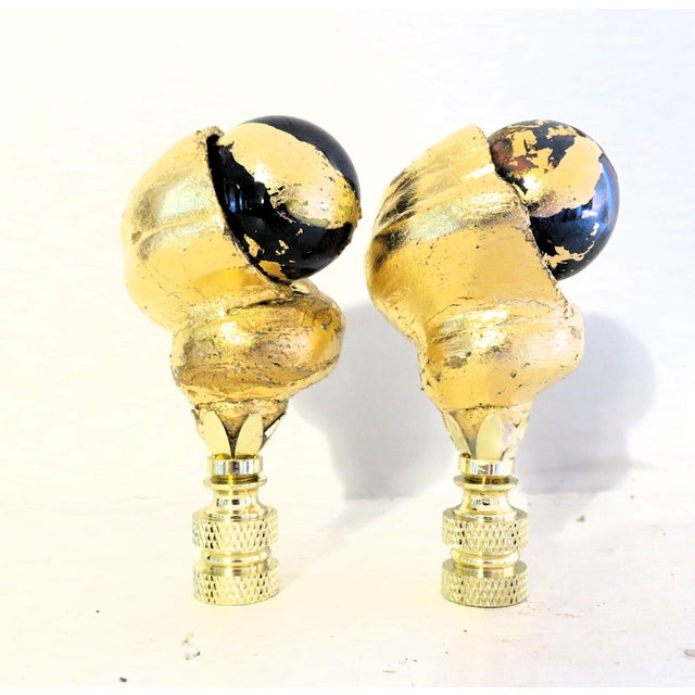 Oversized "Black Pearl" Fiji Shell Lamp finials. Gold leafed with inset of black and gold leaf glass spheres. Each 3" high...