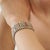 This striking wide statement bracelet showcases 48.70 carats of natural multicolored sapphires in a beautiful mix of...