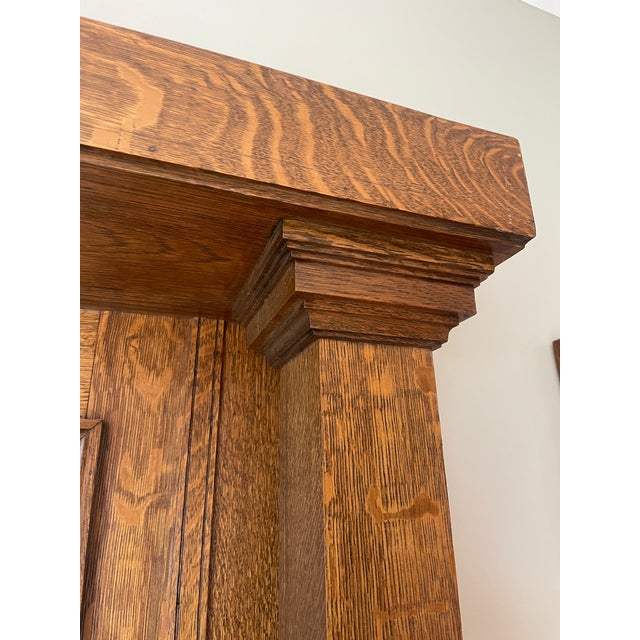 A striking vintage Craftsman-style fireplace mantel executed in solid quarter-sawn oak, showcasing the richly figured...