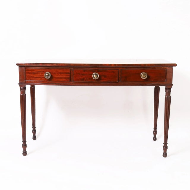 Handsome 19th Century English server handcrafted in mahogany with a marble top set in a crossbanded border on a three...