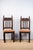 Pair of carved wood side chairs, late 19th century, Spanish. Seats are upholstered with spaced nailheads. The back of one...