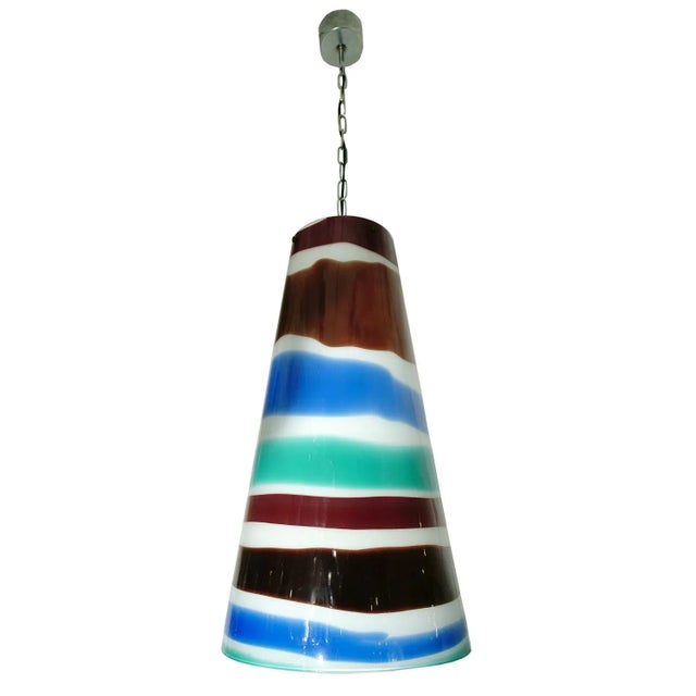 This pendant light was designed by Massimo Vignelli and was produced by Venini in Italy during the 1950s. The piece is...