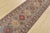 A tribal Caucasian Kazak runner hand-knotted with fine wool on a cotton foundation. This rug features a row of geometric...