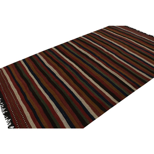 Handwoven in wool, circa 1950-1960, this 6x10 vintage Afghan tribal kilim rug, is an exciting new curation in the Rug &...
