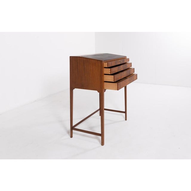 Spectacular and elegant mahogany writing desk from Frits Henningsen, 1950’s Denmark. Inclined writing top with black...