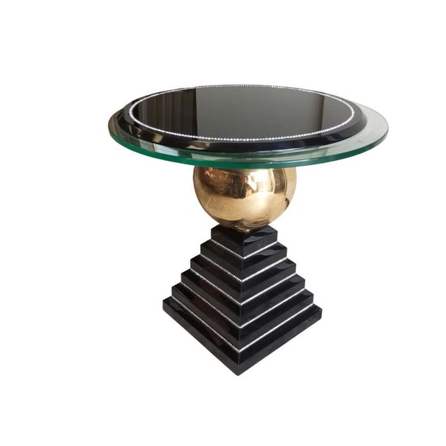 Italian design table attributed to the company "Studio Alchimia." It features a double round top in glass and glossy black...