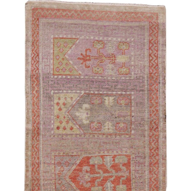 An antique East Turkestan Saph Khotan rug in runner format handmade during the early 20th century. Measures: 2' 2" x 9' 3"...