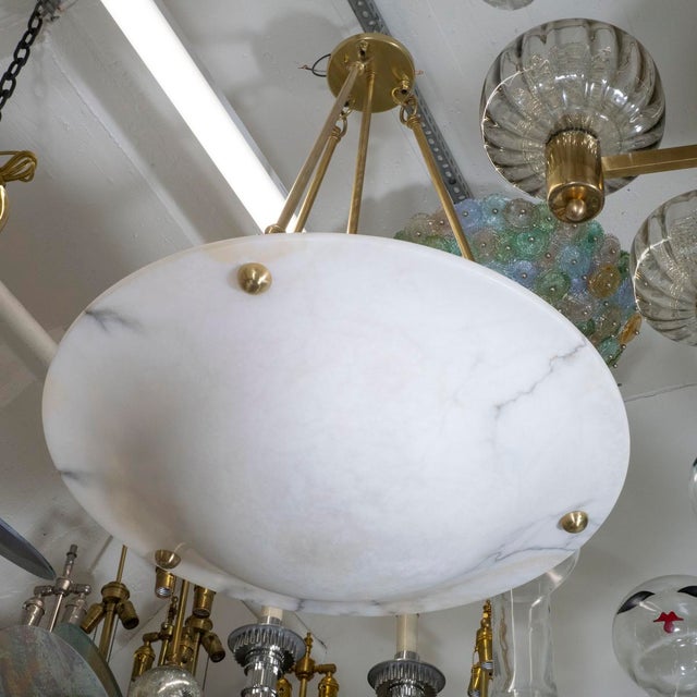 Alabaster dome pendant with brass hardware.