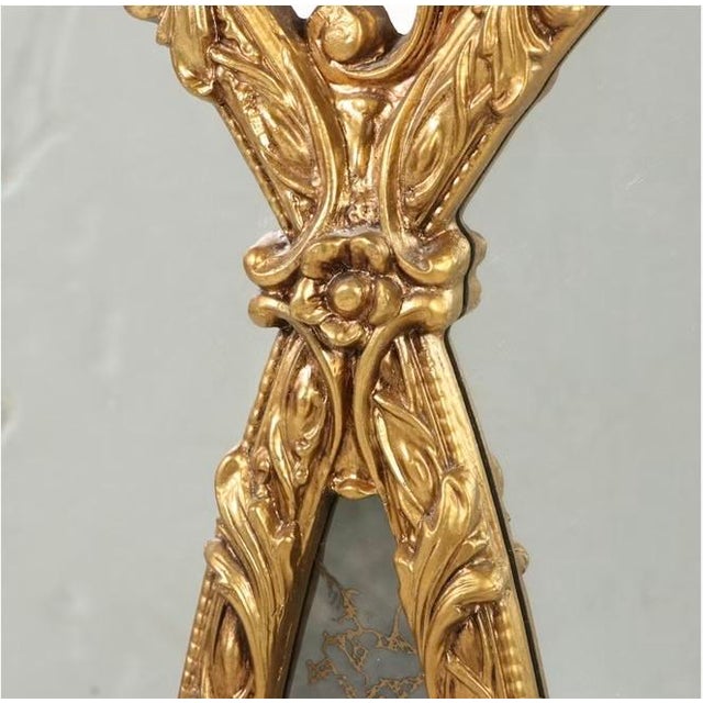 Elegant Hollywood Regency–style giltwood wall mirror, dated 1981. Features a striking triple-oval design with ornate...