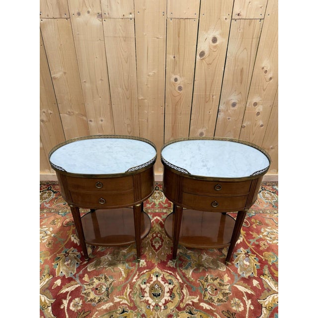 A charming pair of Louis XVI style bedside tables, known as "drums" due to their harmonious cylindrical shape. Crafted...