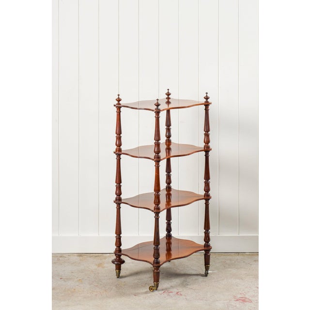 This Victorian Rosewood Whatnot showcases four tiers of scalloped-edge shelves supported by finely turned baluster columns...