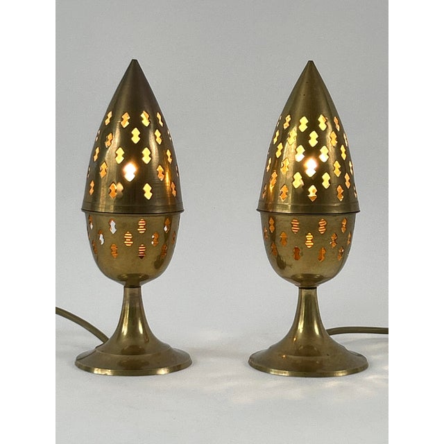 Set of two extremely rare and lovely mid-century modern perforated brass bedside table lamps. Designed and manufactured...