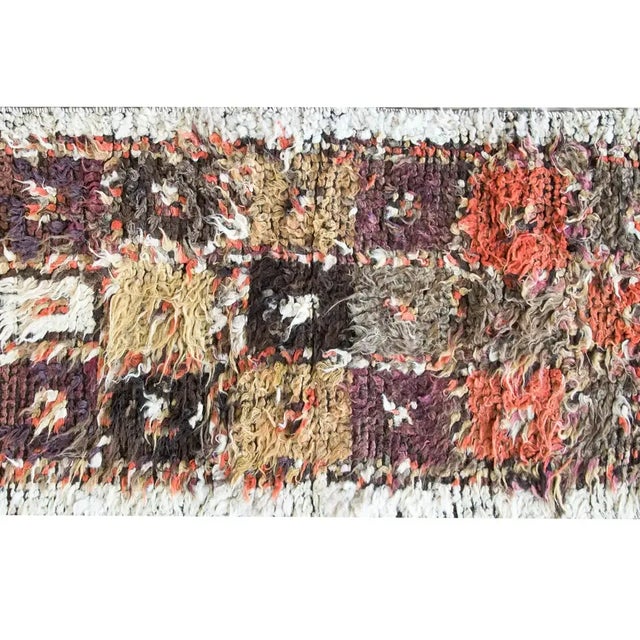 A bold vintage Persian Tulu rug with a patchwork pattern of orange, brown, gray, and gold squares, woven with long shaggy...