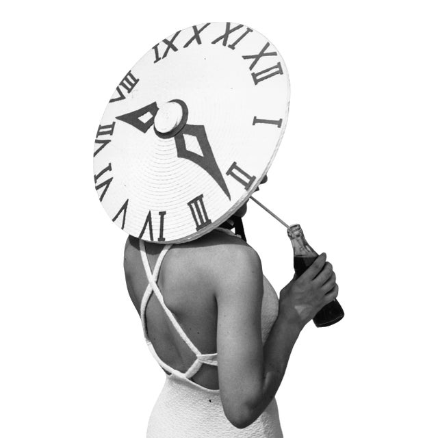 British dancer Rosemary Andree wearing a sunhat with a clock face design on a summer's day at the Roehampton Pool. (Photo...