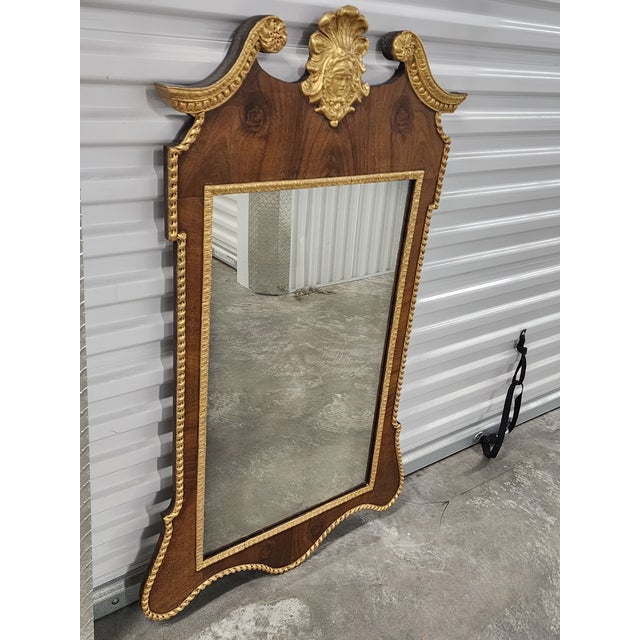 Antique late 19th century George II style mahagony mirror with gilt detailing. The scalloped frame is adorned with rope...