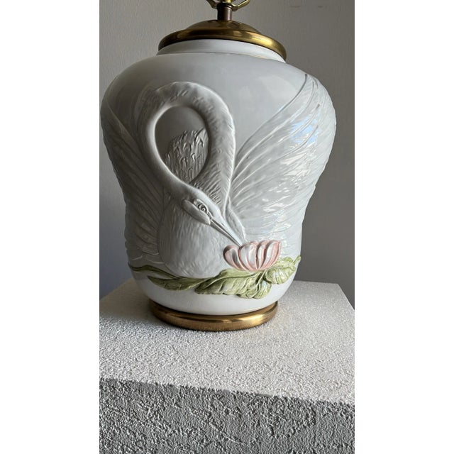 Beautiful porcelain lamp with embossed swan design.