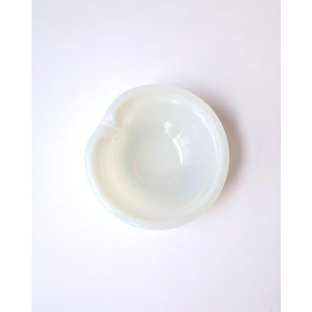 A beautiful Italian Murano white opaline art glass bowl (or ashtray), Midcentury Modern period, in the style of designer...
