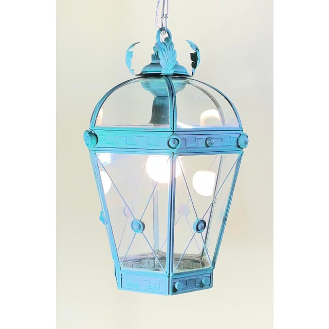Elevate your space with this elegant, restored solid brass hanging lantern chandelier. Featuring a striking, verdigris...