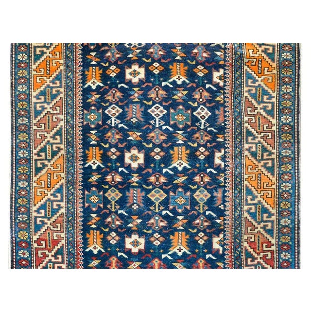 A early 20th century Persian Perepedil rug with a beautiful all-over field of stylized flowers woven in crimson, orange,...