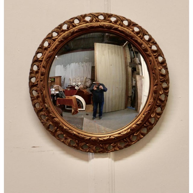 Carved convex gilt wall mirror This is a very attractive mirror has a 3” wide gilt frame which is carved and pierced and...