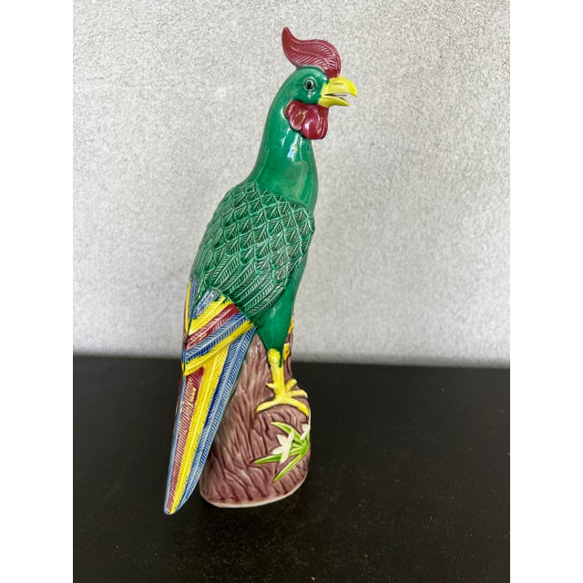 A striking vintage Chinese ceramic rooster featuring a rich emerald green glaze with hand-painted accents in burgundy,...