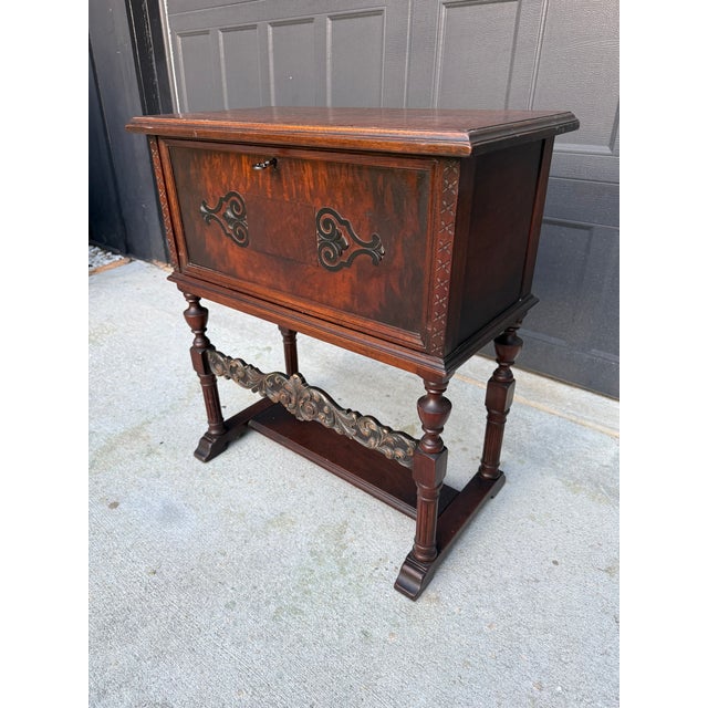 Beautiful vintage wood cabinet featuring an ornate, Old World design with carved detailing, turned legs, decorative...
