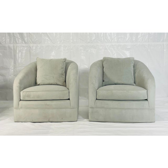 Elegant pair of barrel-back swivel lounge chairs designed and manufactured by Custom Craft Upholsterers, Inc. in Los...