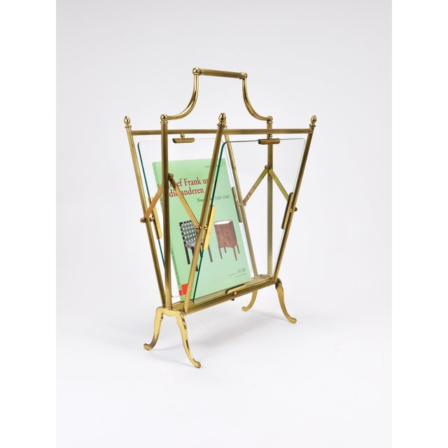 A French Hollywood Regency-style news rack, magazine stand, or book holder, crafted by Maison Jansen in the 1960s....