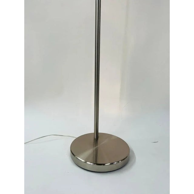 A large modern tall adjustable arched floor lamp with double drum shade. The lamp base is made of metal chrome and the...