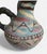 Beautiful handmade Peruvian pottery pitcher featuring bold geometric patterns in desert-inspired tones of turquoise, sand,...
