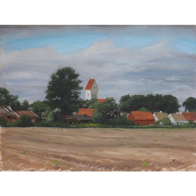 This oil on panel painting captures a serene rural landscape, featuring an old church rising gently above a cluster of...