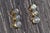 The North Sultan: Bezel Set Past Present and Future Diamond Stud Earrings in Yellow Gold. The earrings feature three round...