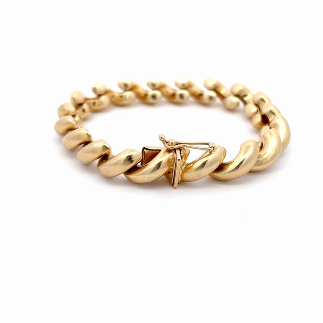 Vintage 14K yellow gold San Marco link bracelet with a twisted design, showcasing a polished finish. The bracelet features...