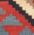 Vintage handwoven Caucasian Shirvan kilim featuring a bold geometric pattern. The vibrant color palette includes shades of...