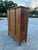 Overview A magnificent and authentic 19th-century Chinese four-door armoire, expertly hand-crafted from solid elmwood...