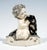 Excellent and rare art nouveau ceramic piece from the early 20th century: a nude putto seated on a rounded, irregularly...
